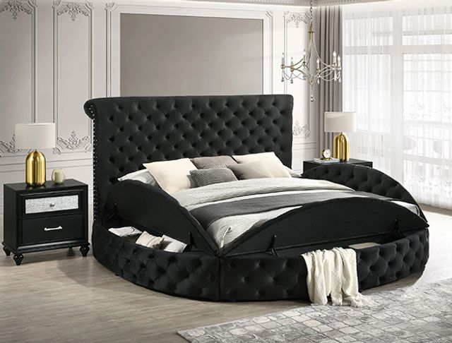 A bedroom with a round bed and two nightstands.