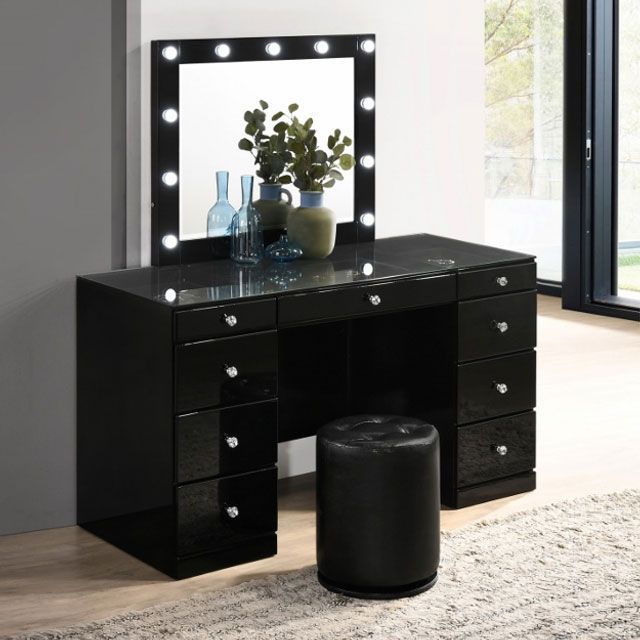 A black vanity with a mirror and a stool