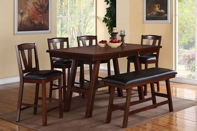 A dining room with a table and chairs and a bench