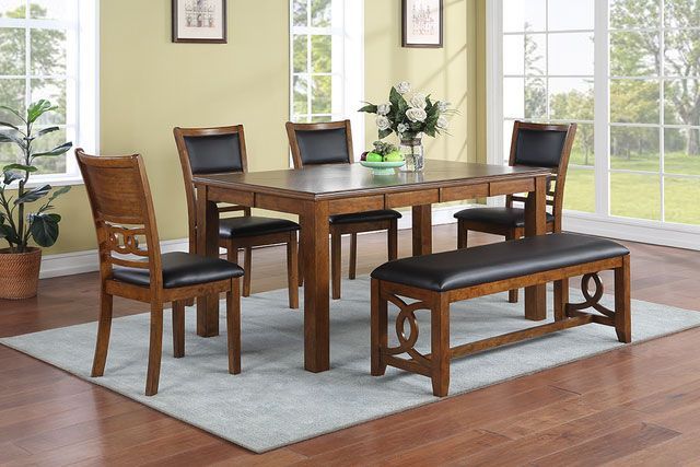 A dining room with a table and chairs and a bench