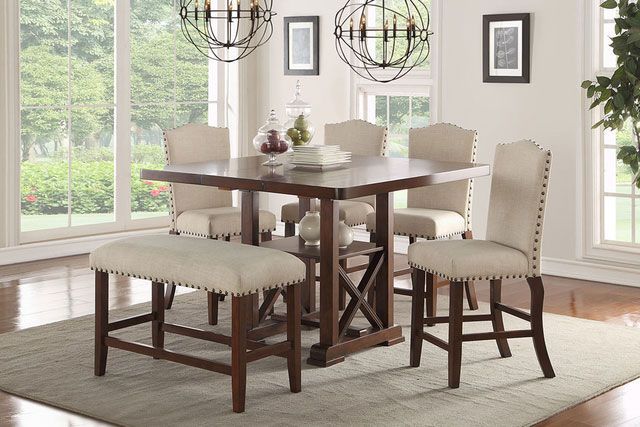 A dining room with a table and chairs and a bench.