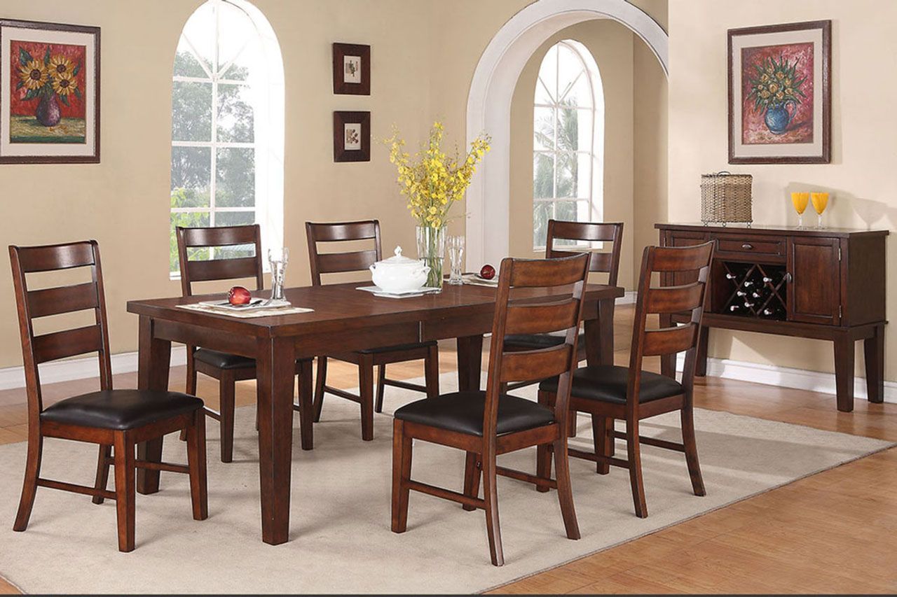 A dining room with a table and chairs in it