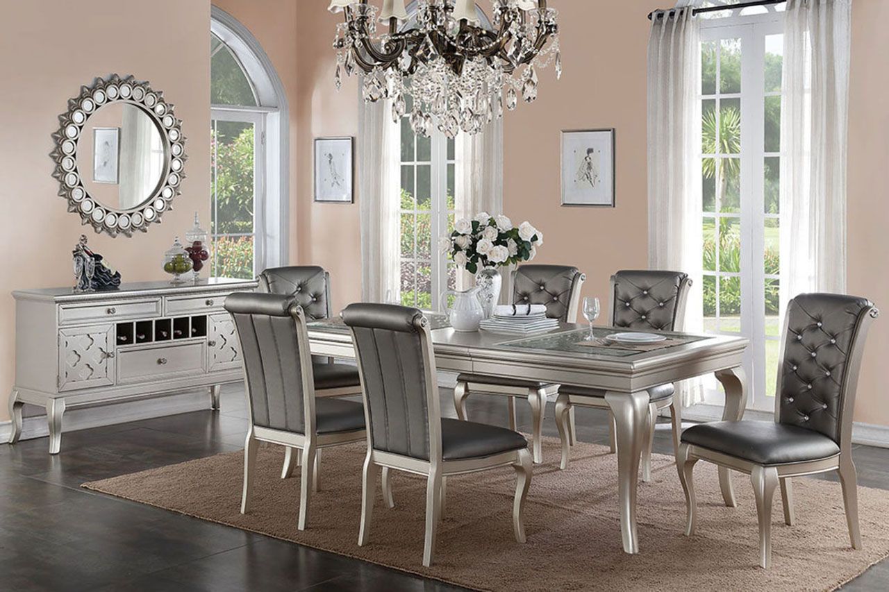 A dining room with a table and chairs and a chandelier.