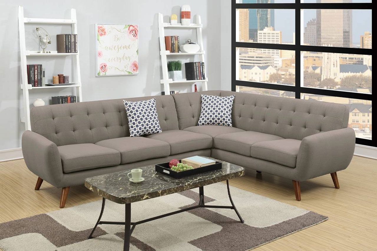 A living room with a sectional couch and a coffee table