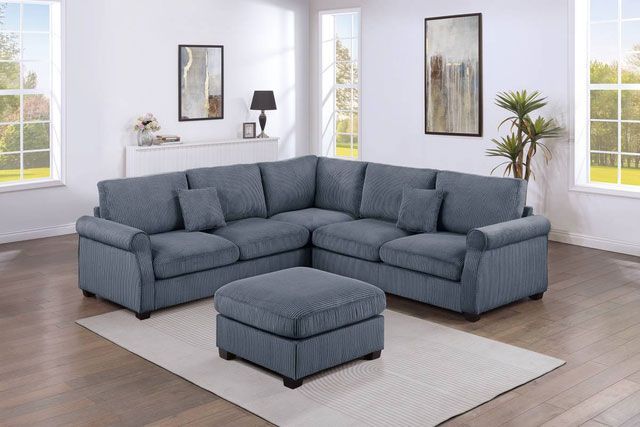 A living room with a sectional couch and ottoman.