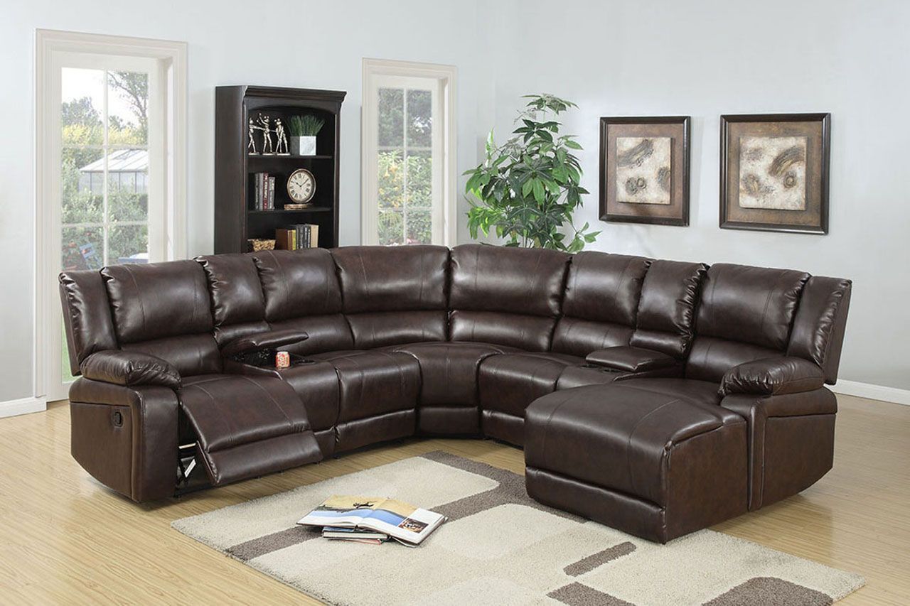 A large brown leather sectional couch is sitting in a living room.