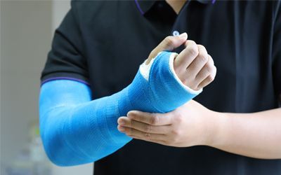 A man with a blue cast on his arm.