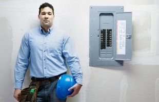 Electrician standing near electrical panel