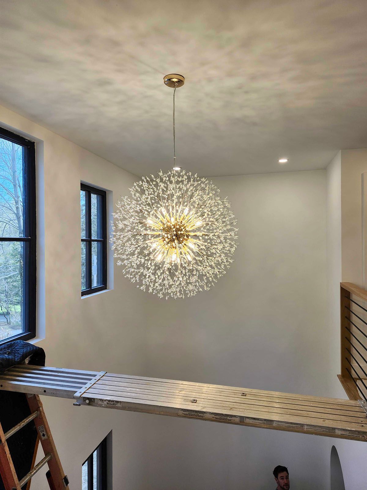 Large spherical chandelier hanging from a high ceiling