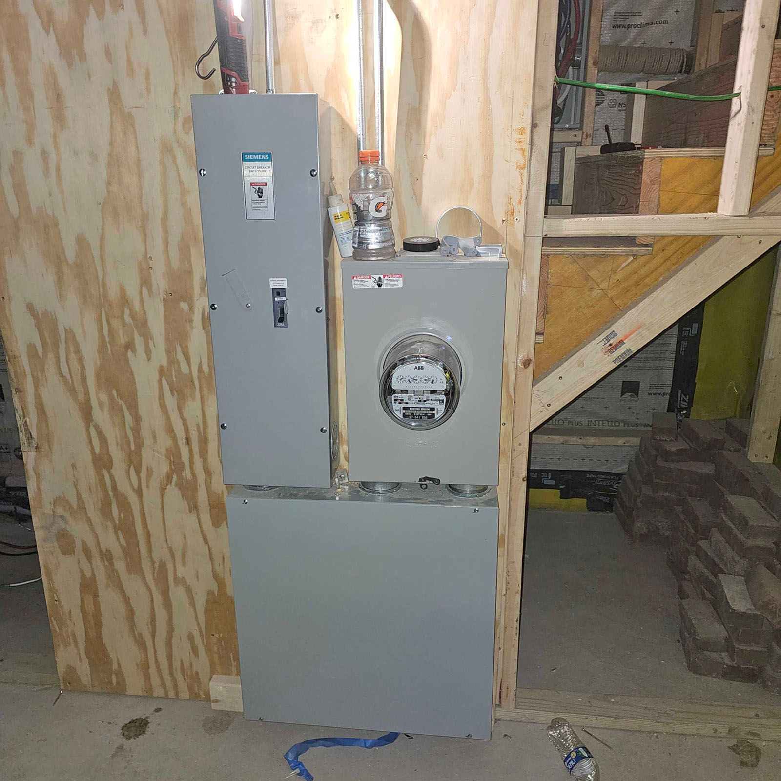 Electrical panel with meter and breaker boxes, installed on a wall