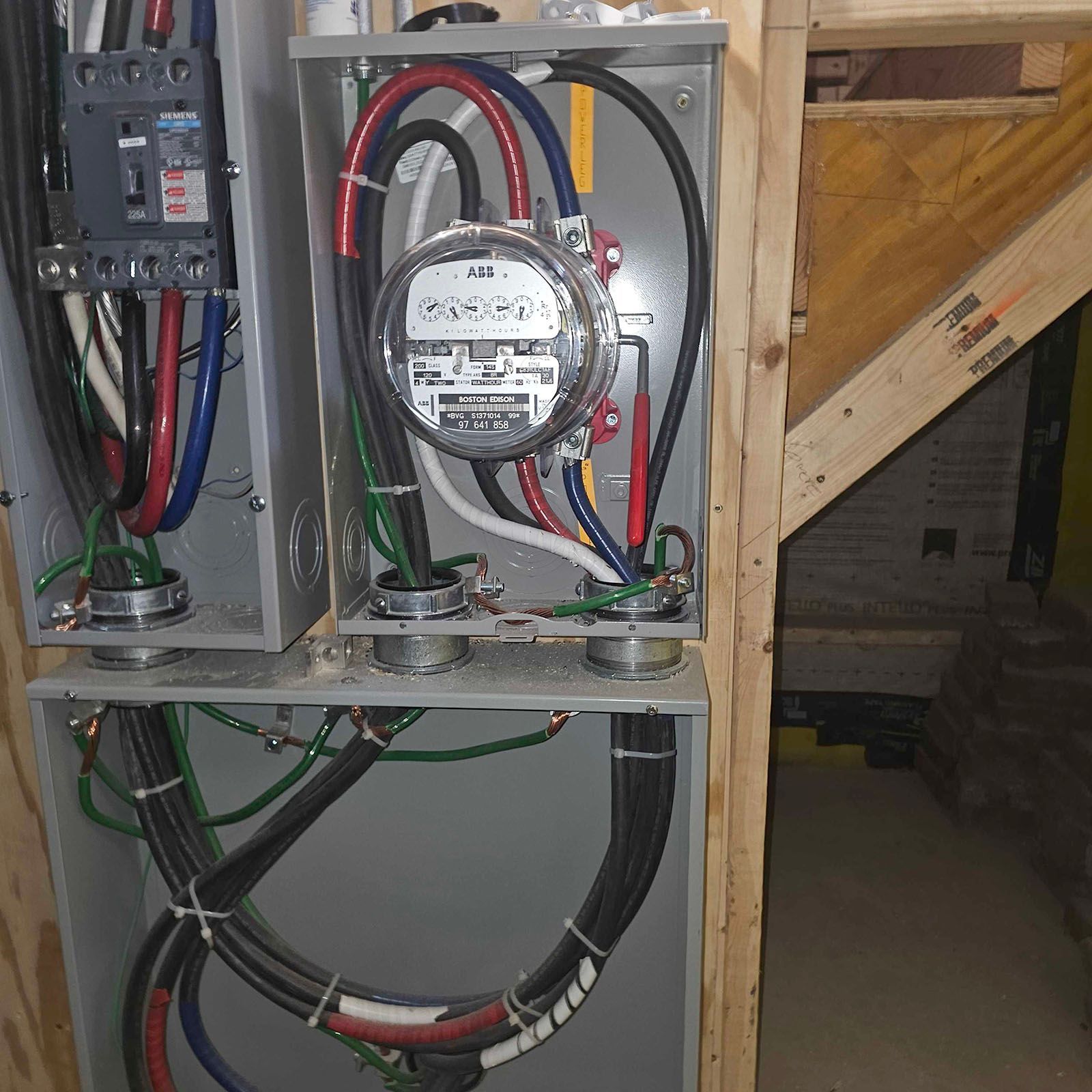 Electrical meter and panel with wires in a wooden frame