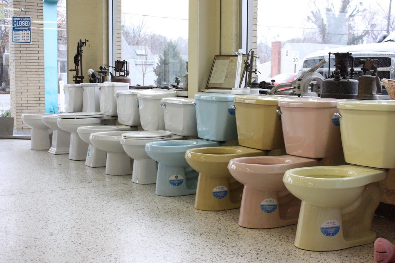 A row of toilets are lined up in a store