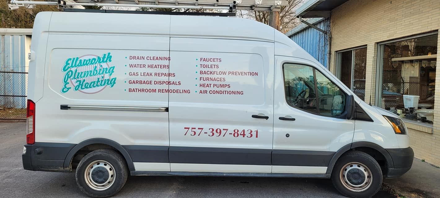 A white van is parked in front of a building.