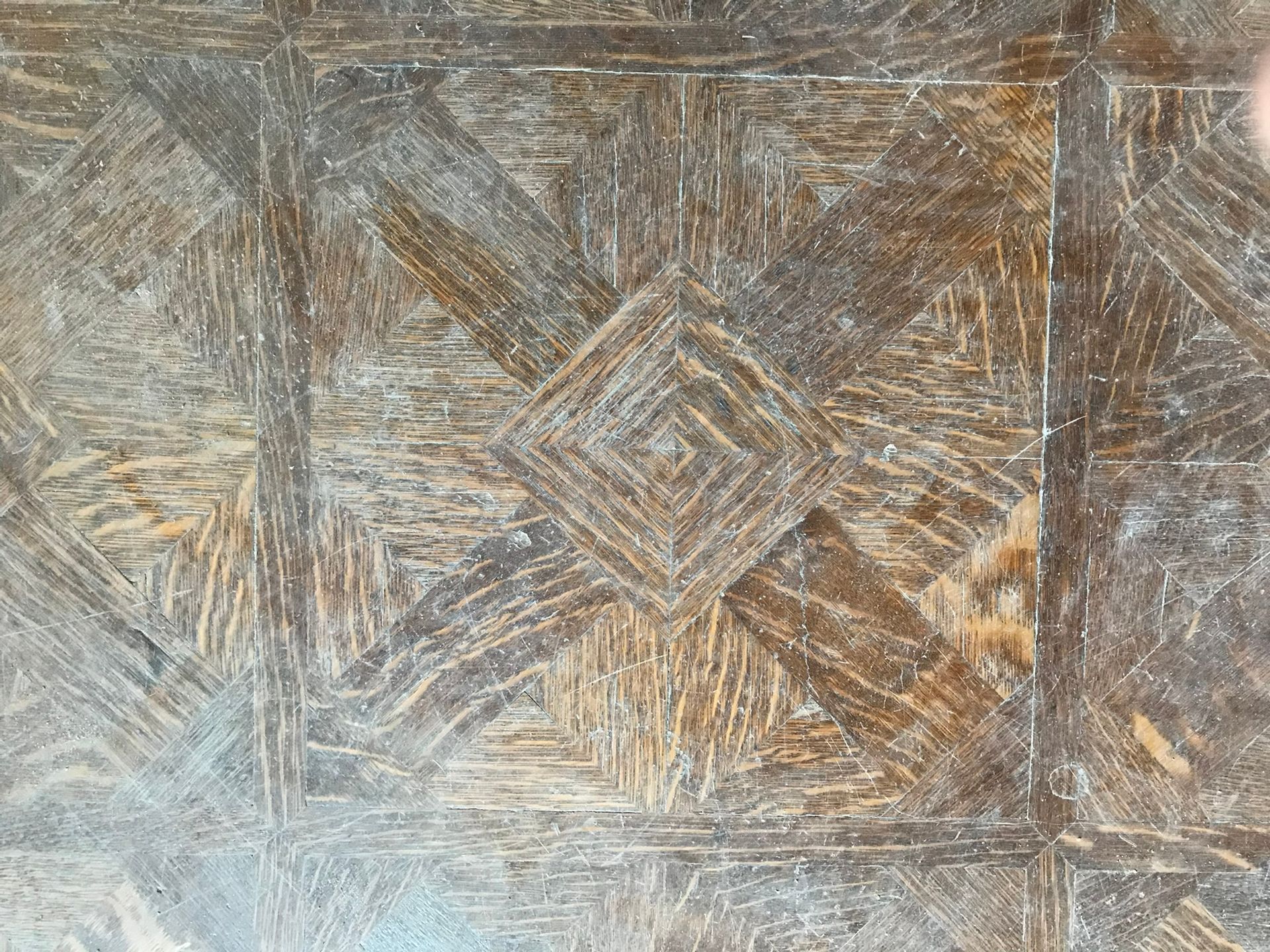 Brown and gray patterned floor tile with a diamond design.
