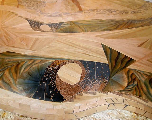 Abstract wooden inlay art with geometric shapes and swirling patterns, earthy tones.