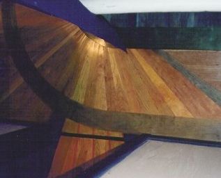 Wooden ceiling detail with beams, fan-shaped panels, and blue and green accents.