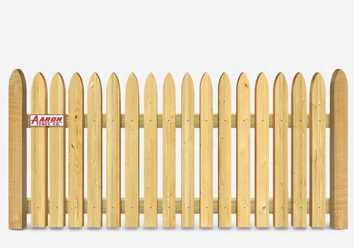 A wooden picket fence is sitting on a white surface.