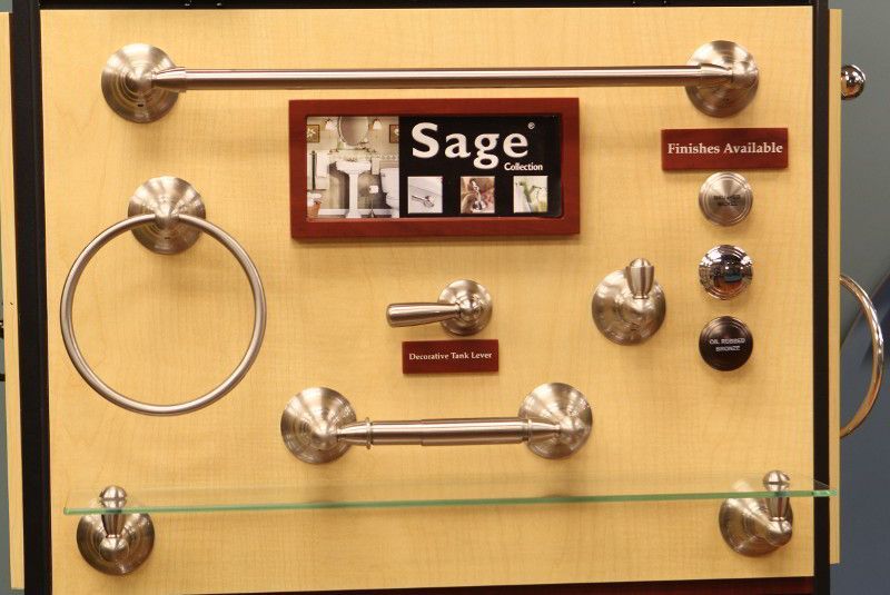A display of sage bathroom hardware on a wooden board