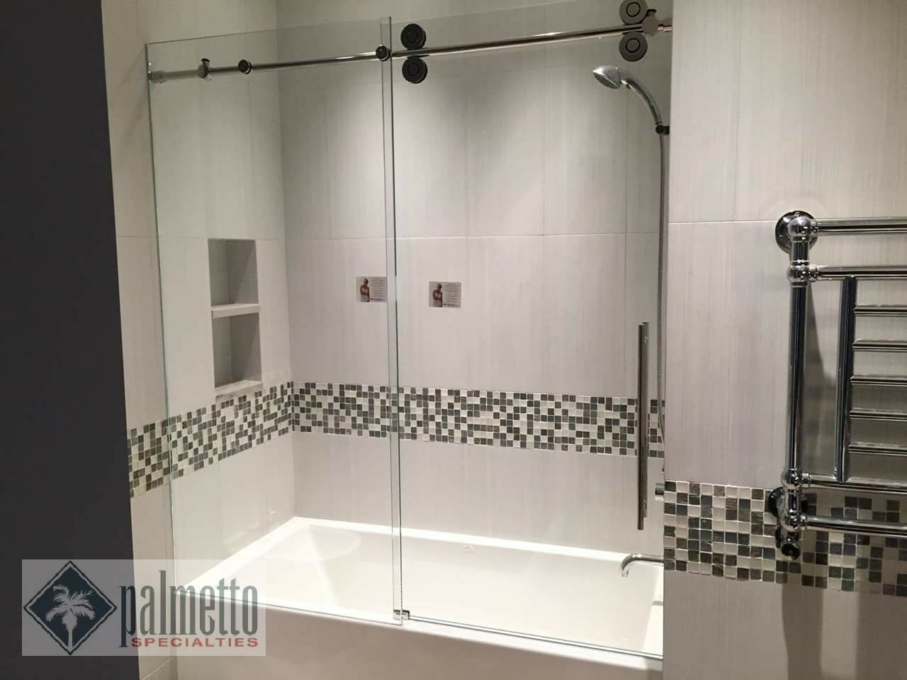 A bathroom with a sliding glass shower door