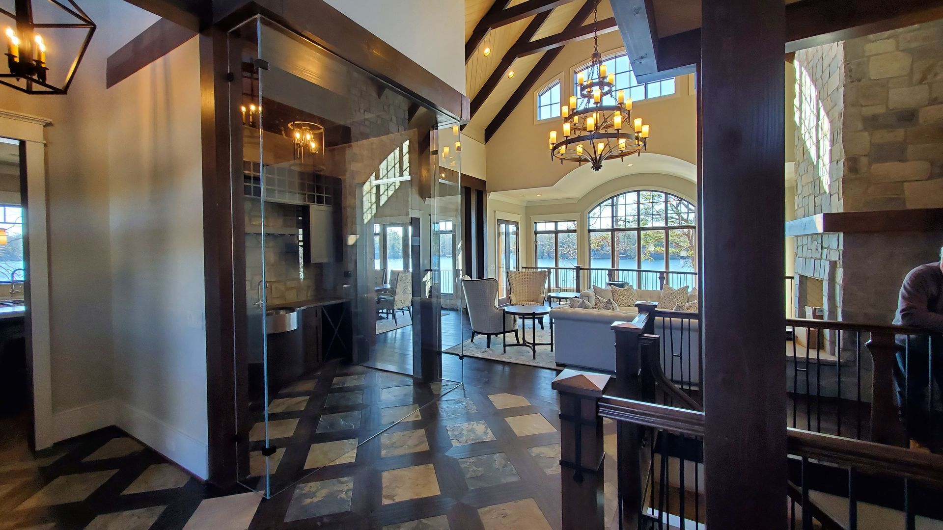 A large living room with a lot of furniture and a chandelier.