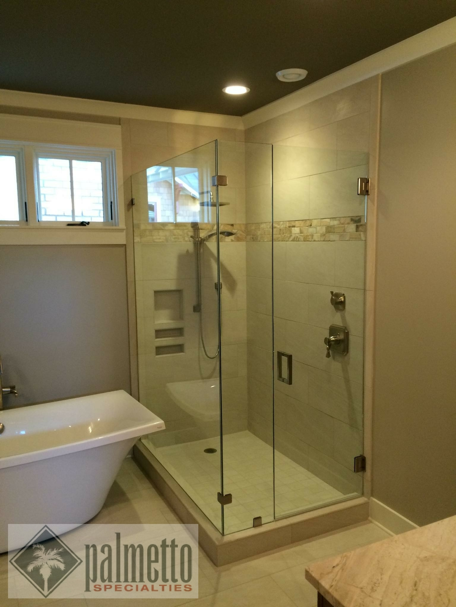 A bathroom with a walk in shower and a bathtub