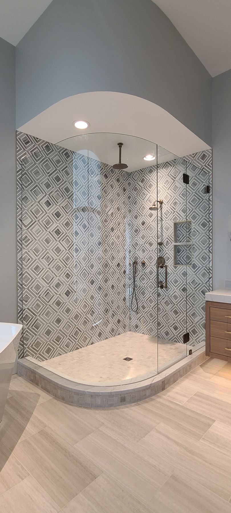 A bathroom with a walk in shower and a bathtub.