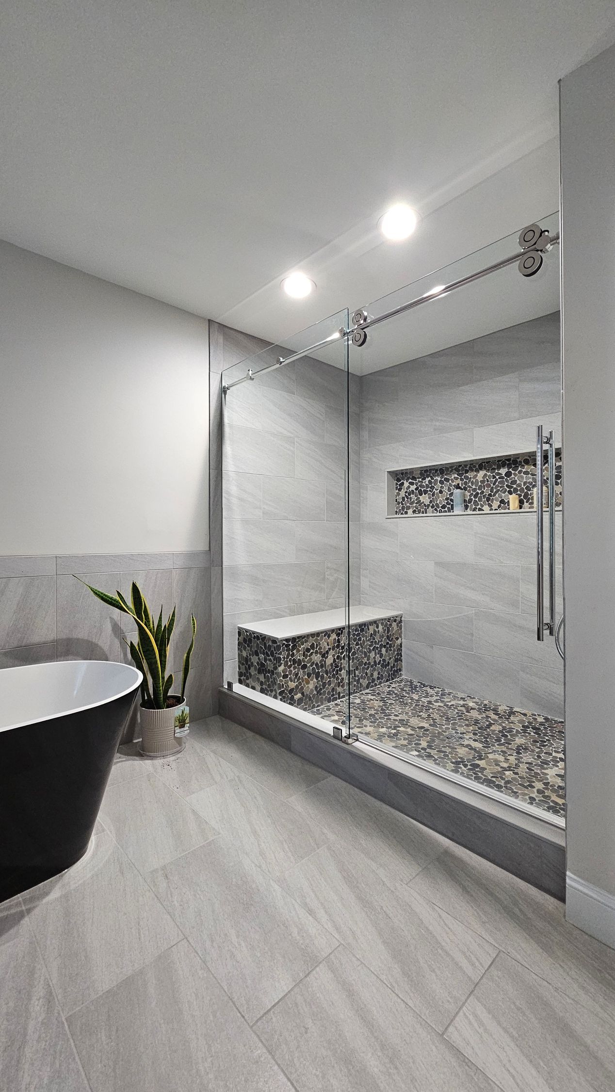 A bathroom with a tub and a walk in shower.