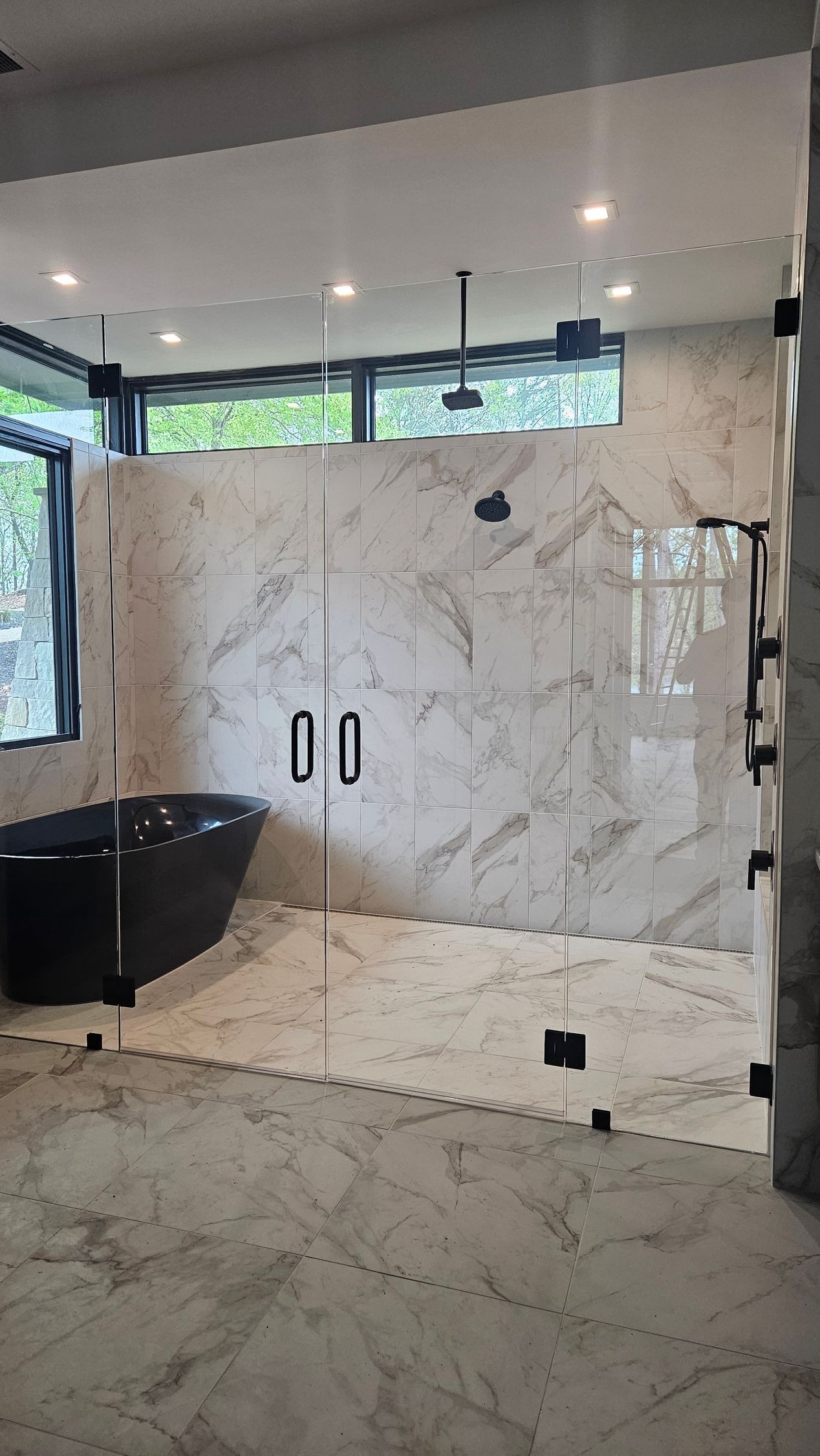 A bathroom with a walk in shower and a bathtub.