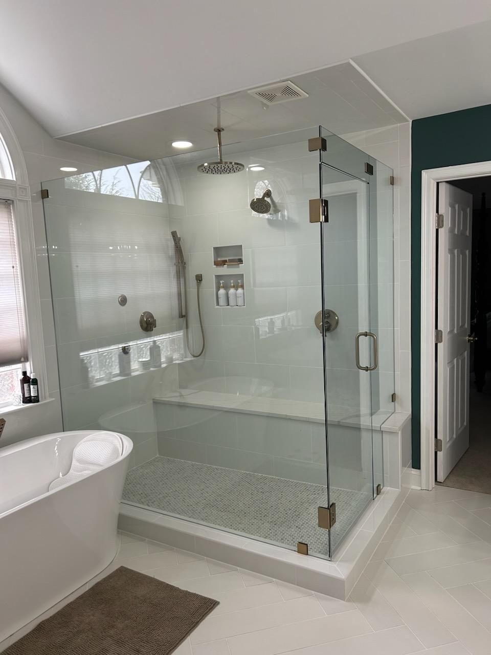 A bathroom with a bathtub and a walk in shower.
