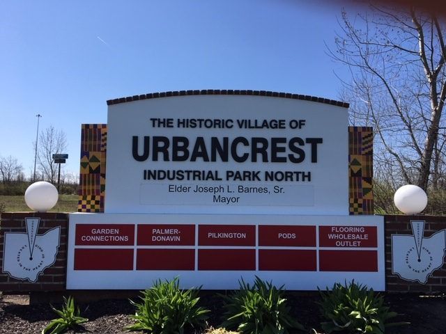 Sign for the Historic Village of Urbancrest, Industrial Park North, with the Mayor's name listed.