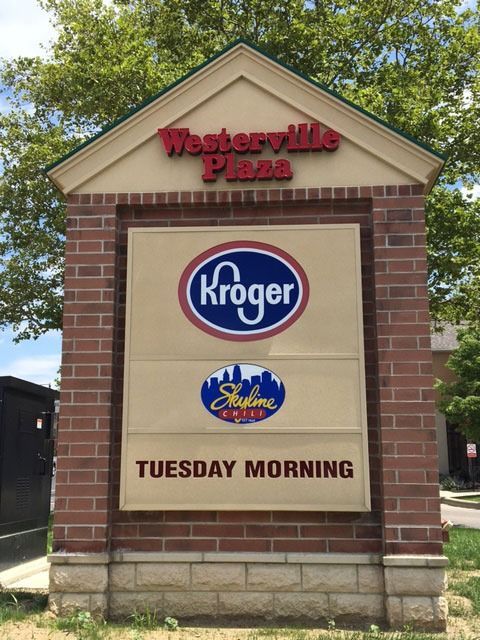Sign for Westerville Plaza with Kroger, Salon Shalom, and Tuesday Morning logos. Brick structure, beige panel.