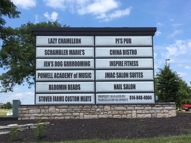 Sign displaying businesses: Lazy Chameleon, Scrambler Marie's, Jen's Dog Grooming, Powell Academy, Bloomin Beads, Stover Farms, PS Pub, China Bistro, Inspire Fitness, INAC Salon, Nail Salon.