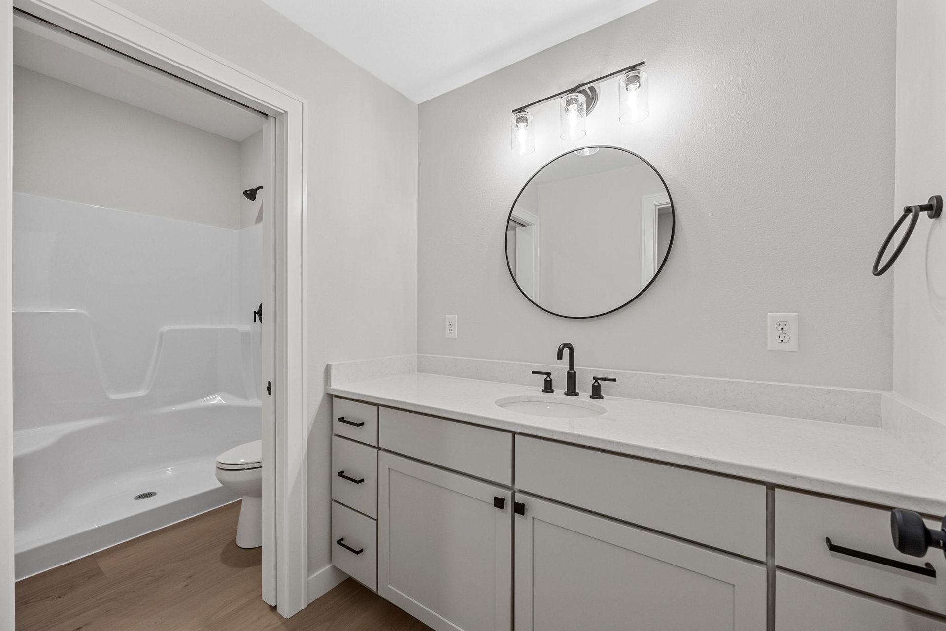 A bathroom with a sink , mirror and bathtub.