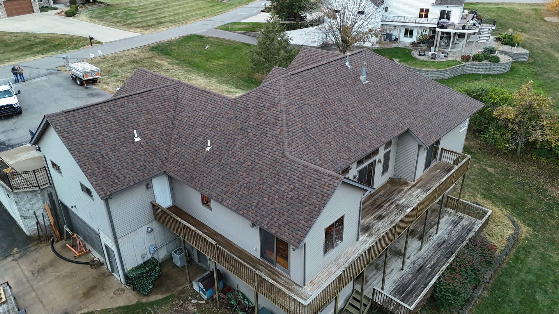 An aerial view of a large house with a brown roof.