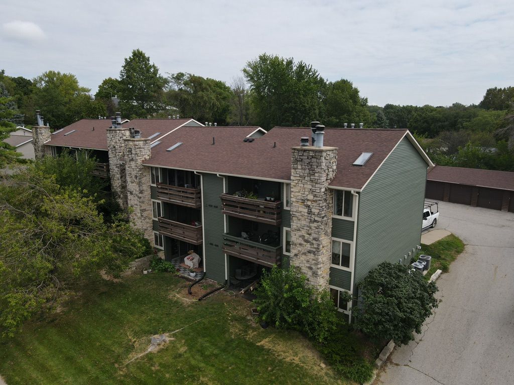 An aerial view of a apartment building with a red roof