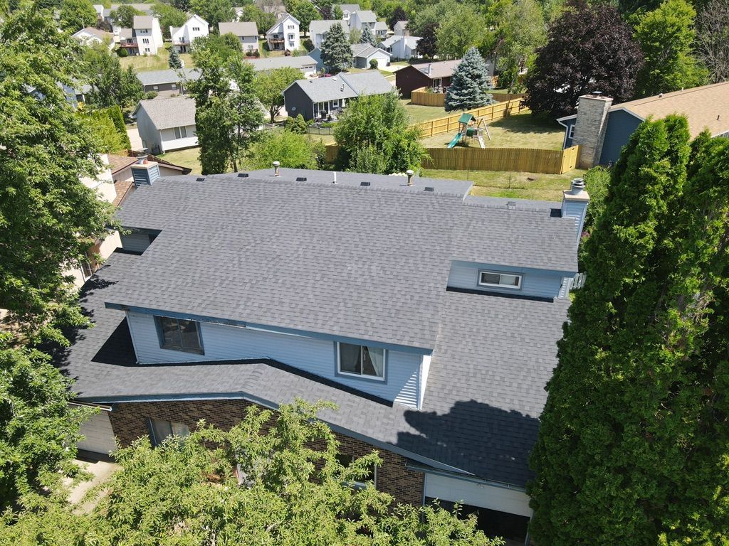 An aerial view of a house with a black roof