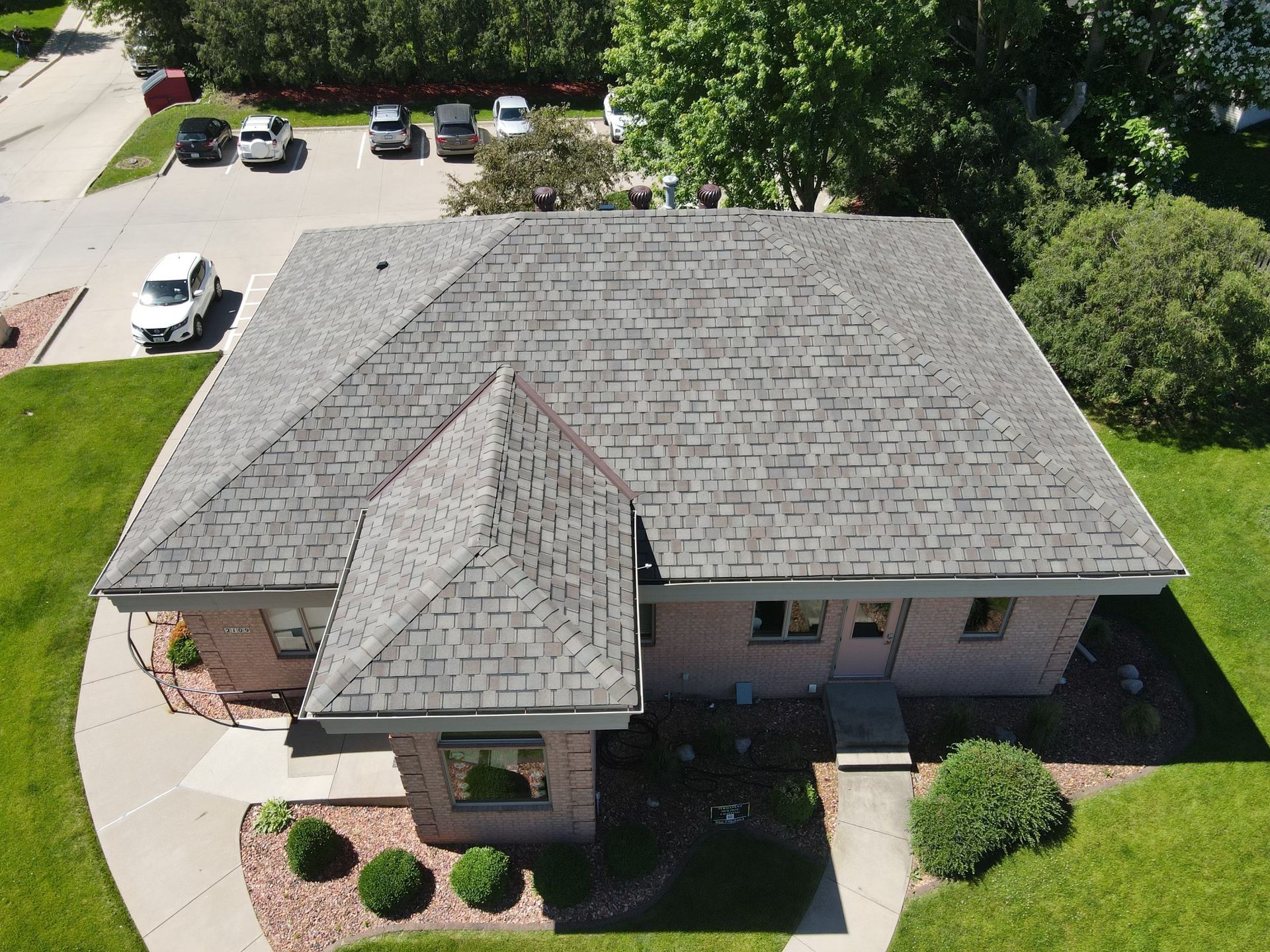 An aerial view of a house with a gray roof.