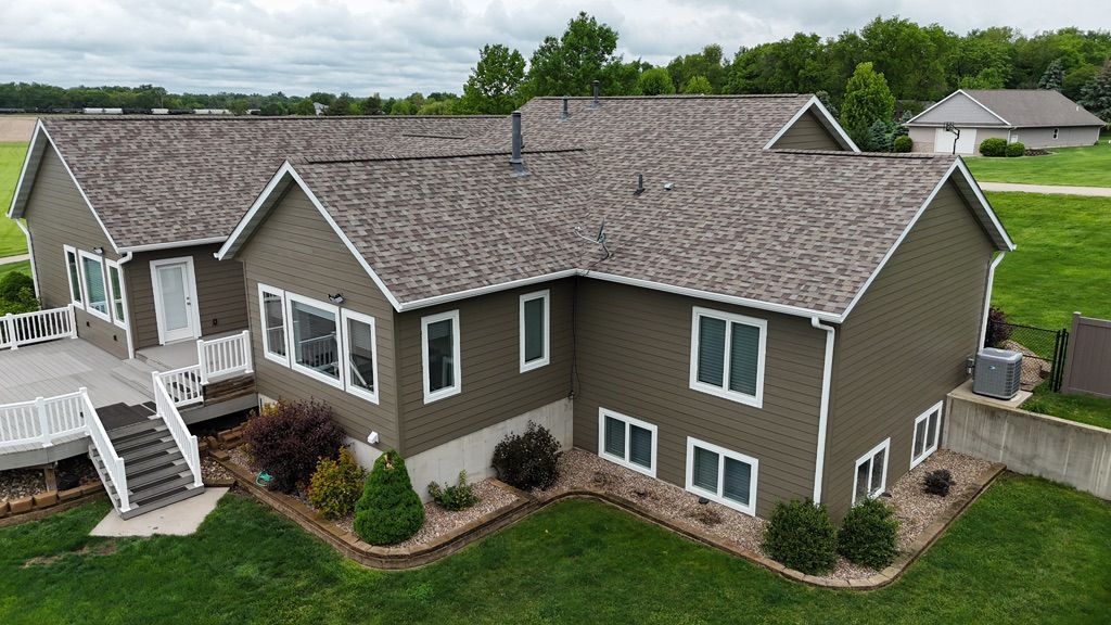 An aerial view of a large house with a gray roof.