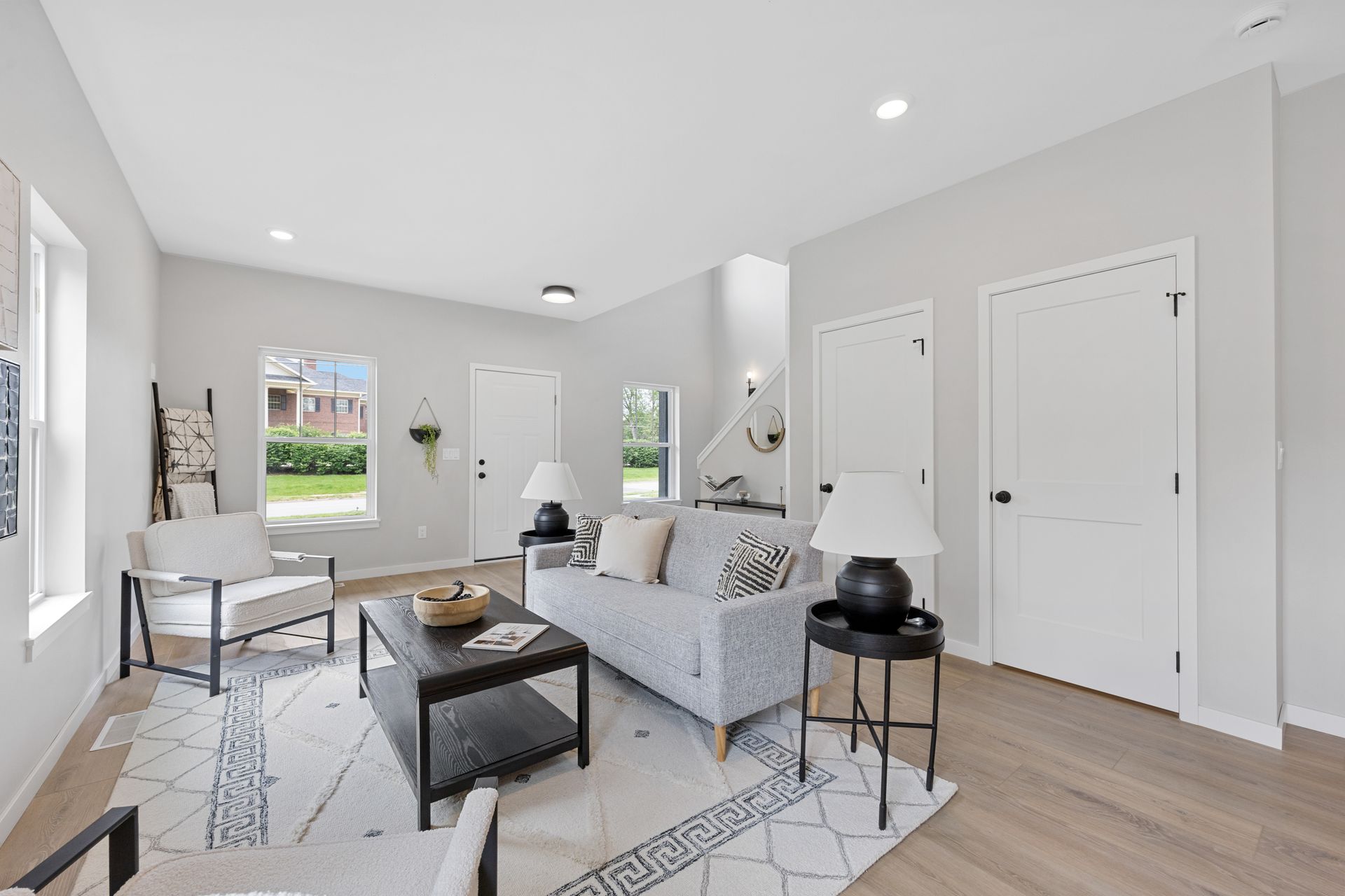 A living room with a couch , chairs , and a coffee table.