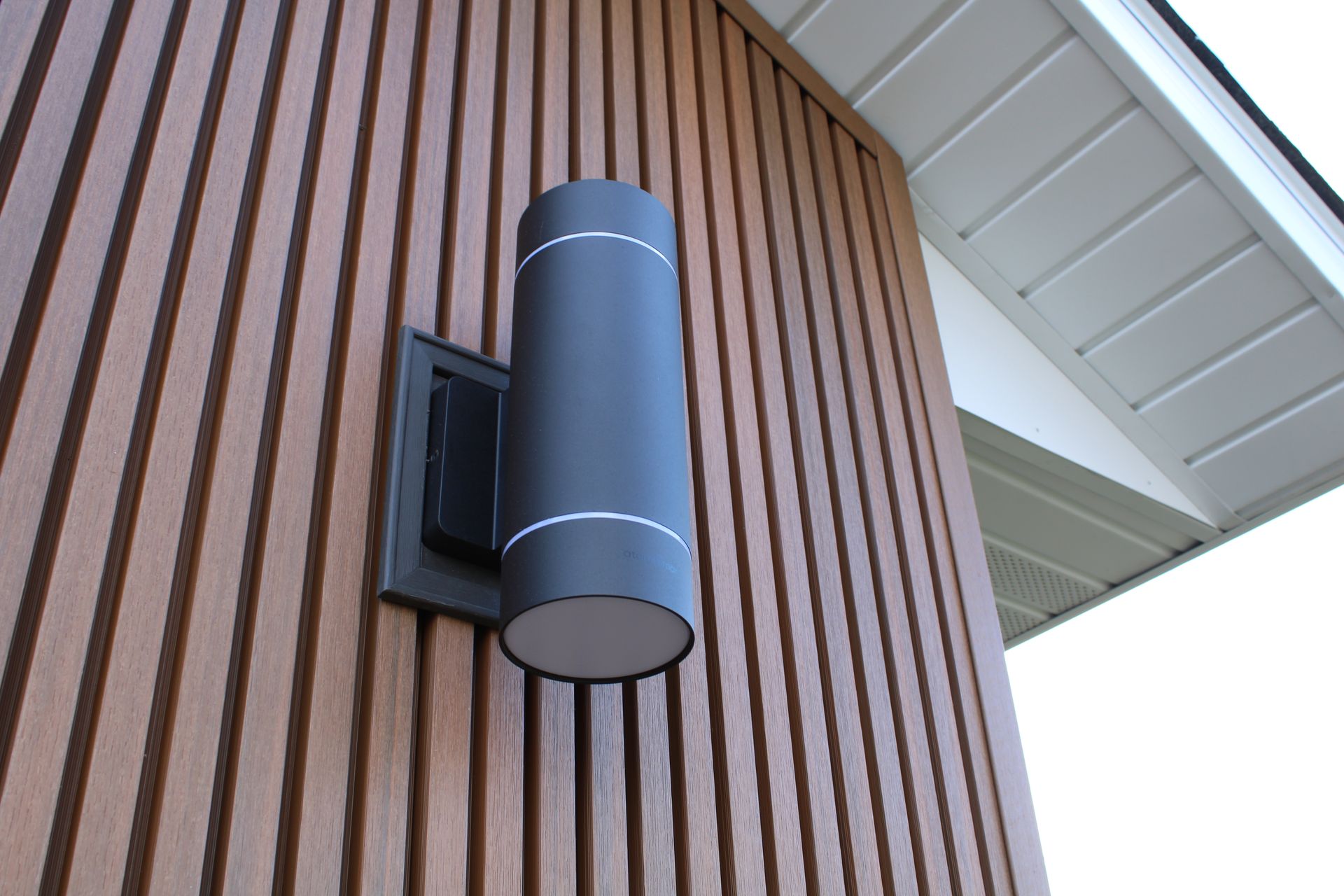 There is a light on the side of a building.