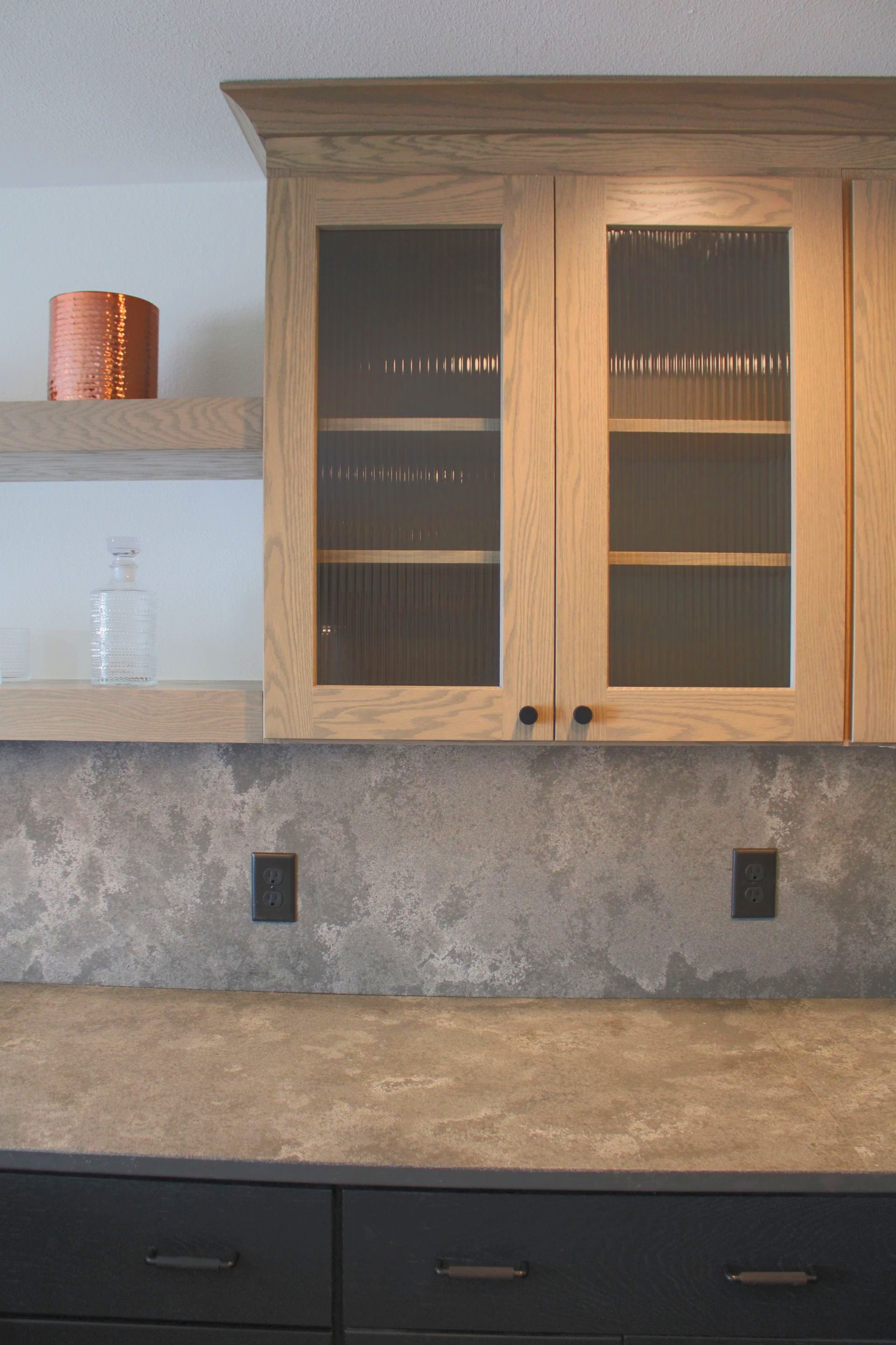 A kitchen with wooden cabinets and a granite counter top