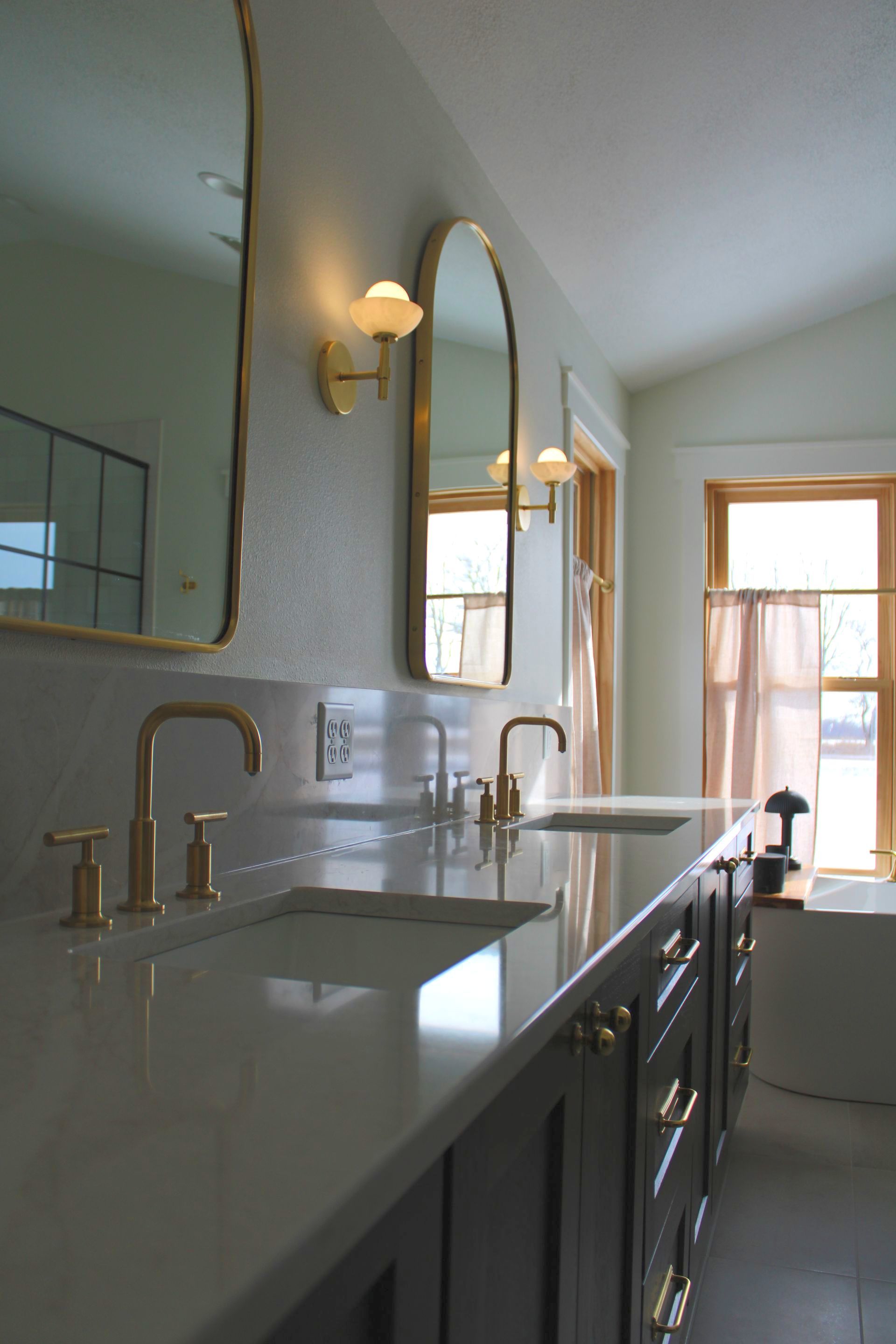 A bathroom with two sinks and two mirrors