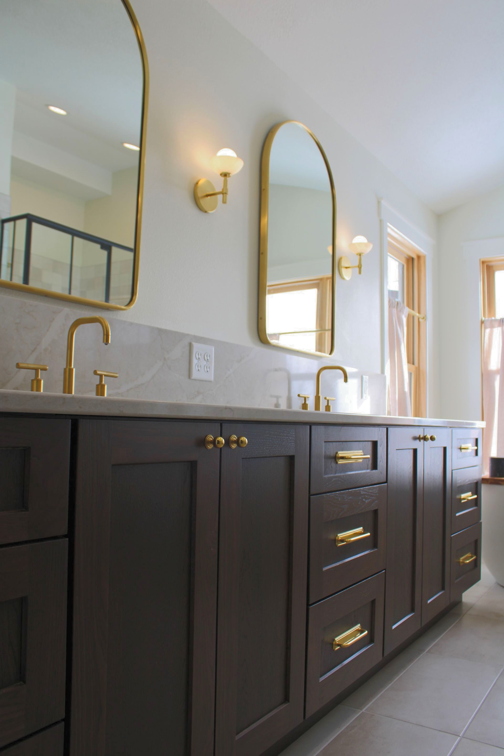A bathroom with two sinks and two mirrors.