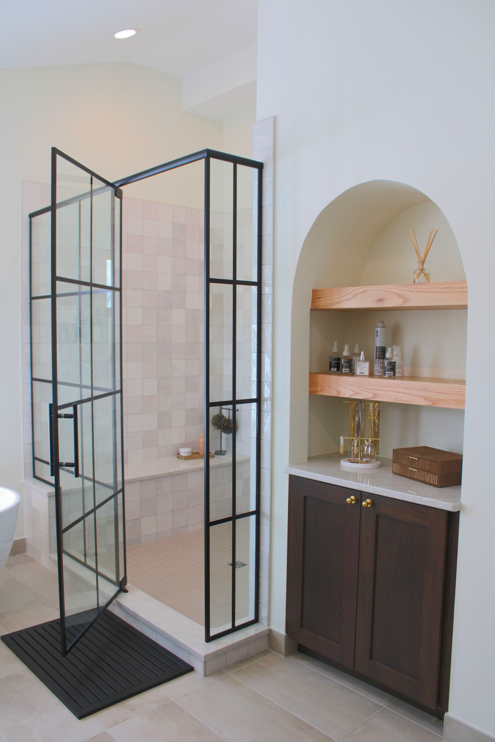 A bathroom with a walk in shower and a sink.