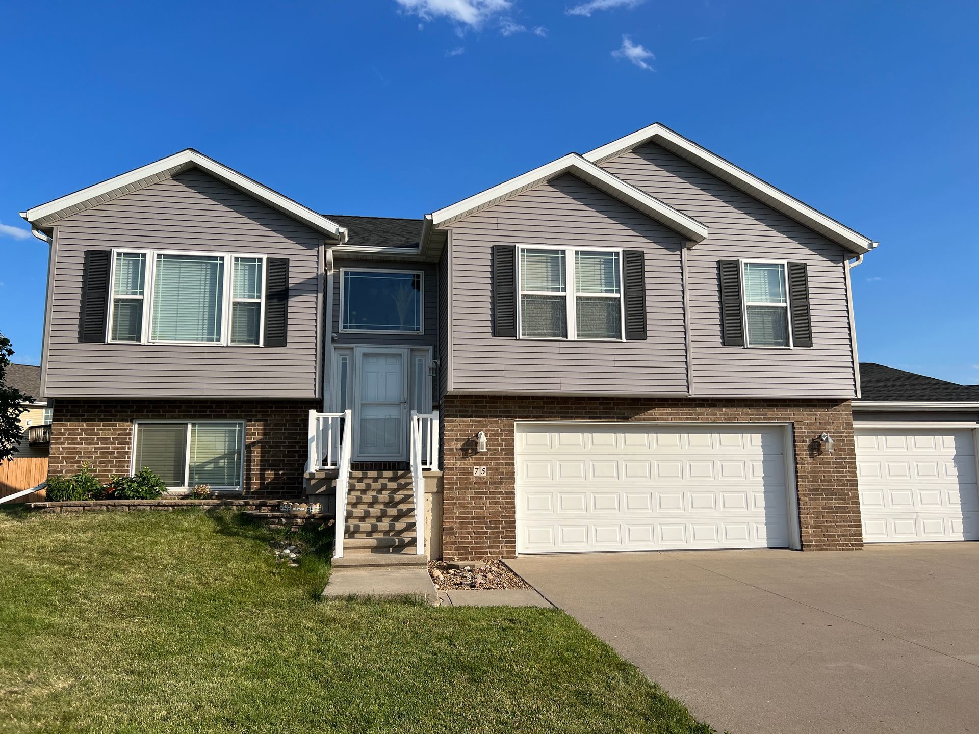 A large house with a lot of windows and shutters