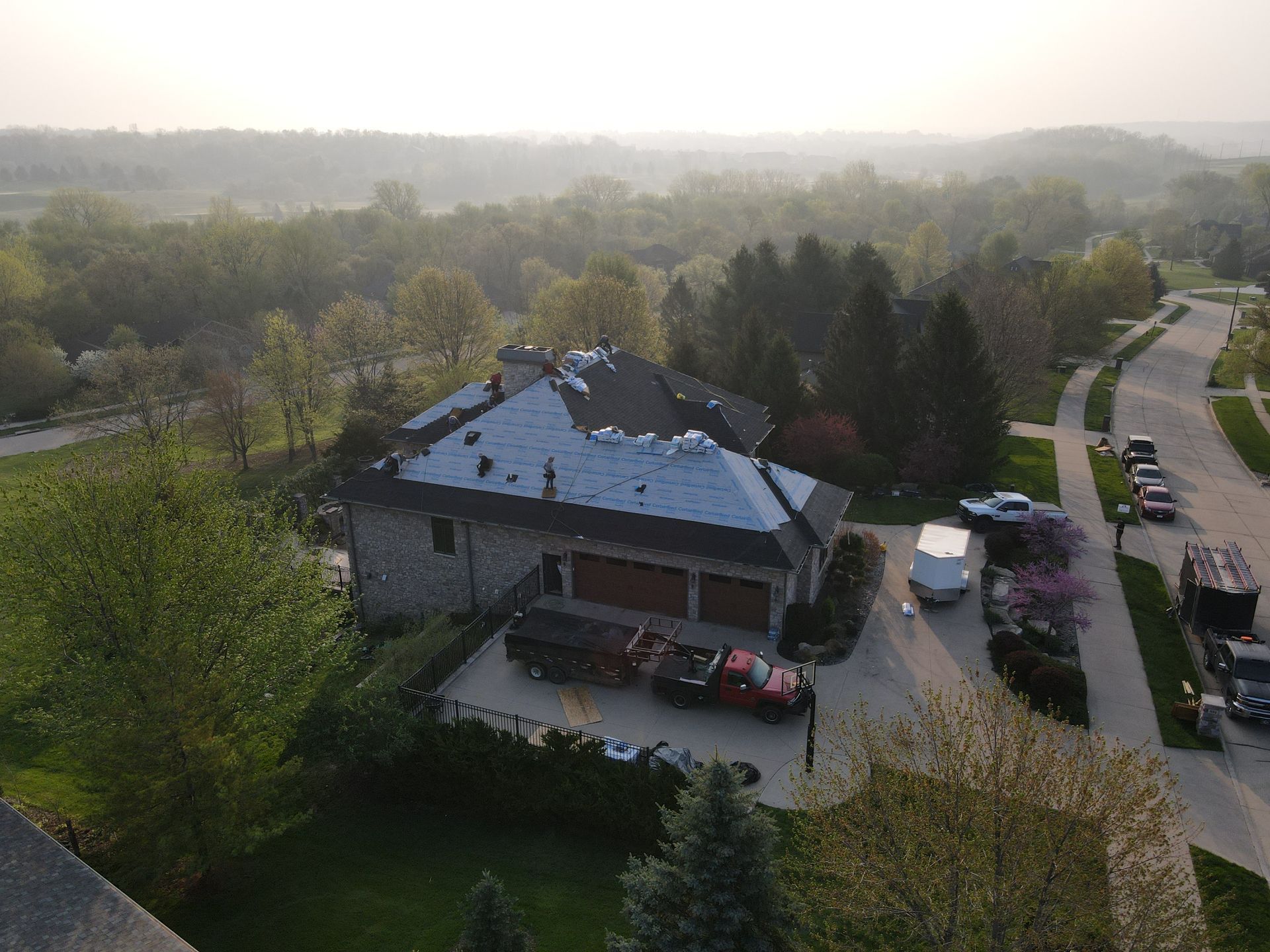 An aerial view of a house with a roof that is being installed.