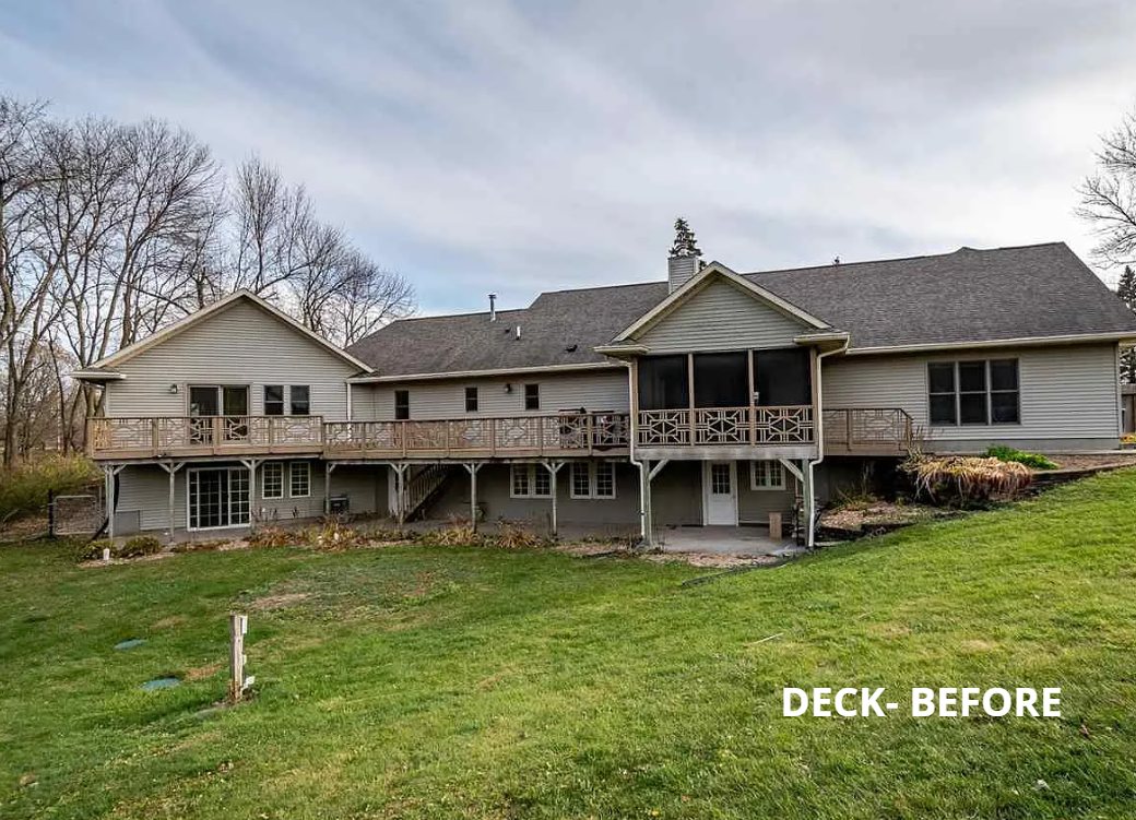 A large house with a large deck in the backyard.