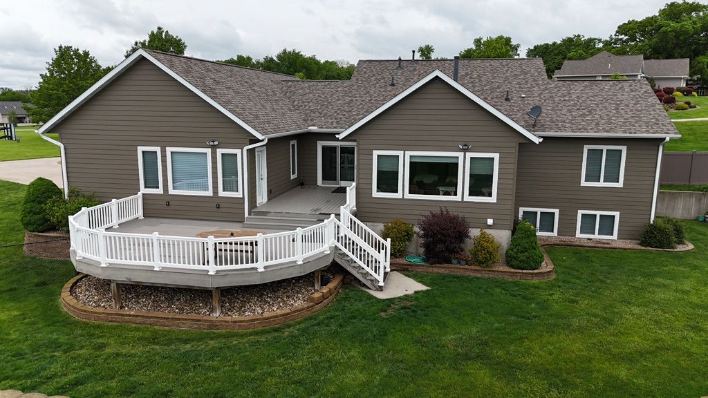 An aerial view of a large house with a large deck.