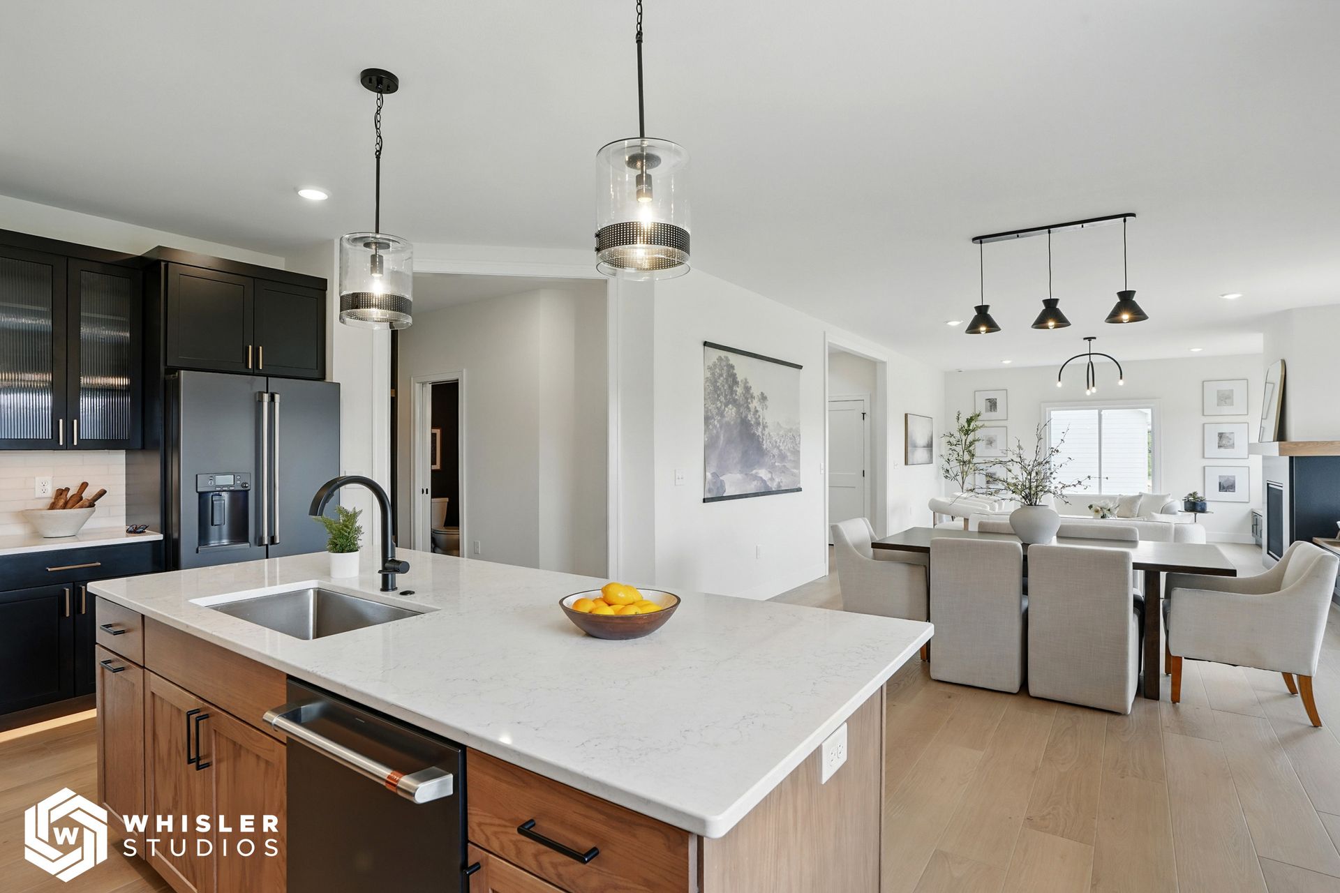 A kitchen with a large island and a sink.