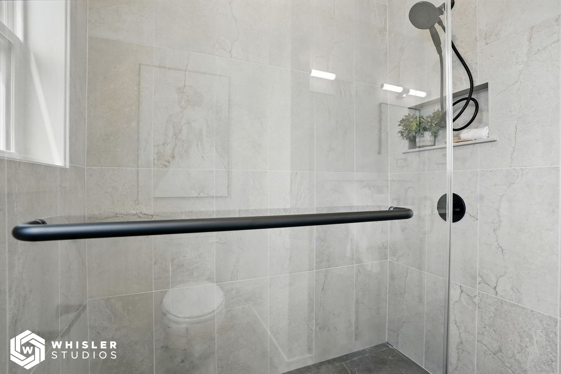 A bathroom with a walk-in shower and a toilet.